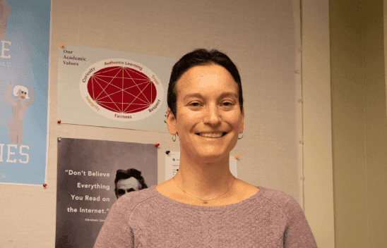 In the basement classroom of Phillips Hall, students gather around a Harkness table, course readers spread open before them. They discuss a reading — challenging, agreeing, and searching through the text to corroborate their ideas. Seated among them, Dr. Betty Luther-Hillman observes with a smile, occasionally stepping in gently to guide the discussion back on track. 
