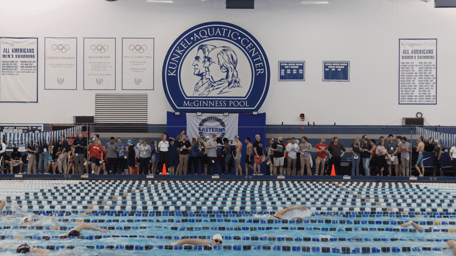 Under the natatorium lights, the pool looks almost too calm, a flat sheet of blue broken only by ripples from the last heat. Swimmers settle onto the blocks; the whistle snaps, and the calm water shatters into spray. On Thursday, Feb. 12, Big Red’s varsity swimming and diving team made the 10-hour journey to Lancaster, Pa., where they spent the next four days competing at the 2026 Eastern Interscholastic Swimming & Diving Championships. The contest, held annually at the Kunkel Aquatic Center at Franklin & Marshall College, is, for many preparatory schools and clubs, the principal event in the competitive season. Faced off against the region’s most talented swimmers and divers, Easterns, as it is colloquially called, is unlike any other meet.